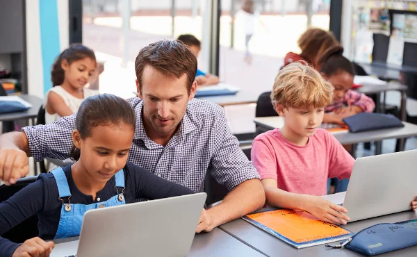 teacher-with-student-working-on-laptop-about-communication